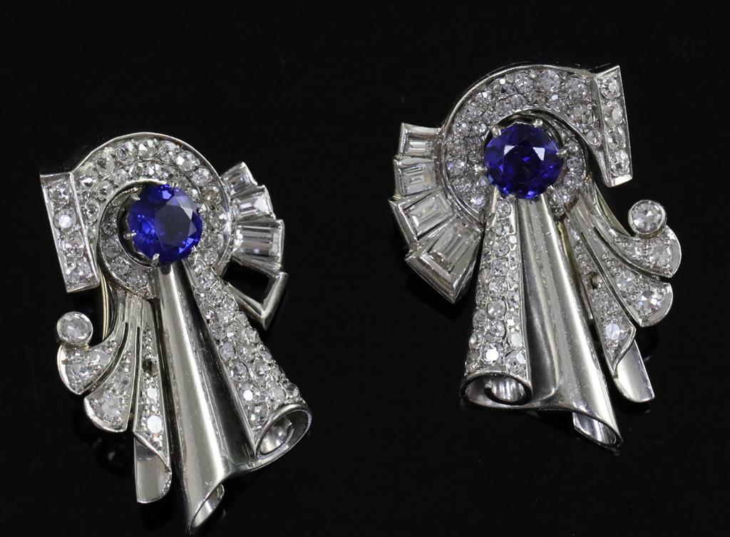 A pair of diamond and synthetic? sapphire clips in white metal settings (tests as platinum), white metal fitments